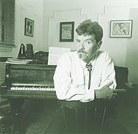 man sitting in front of piano